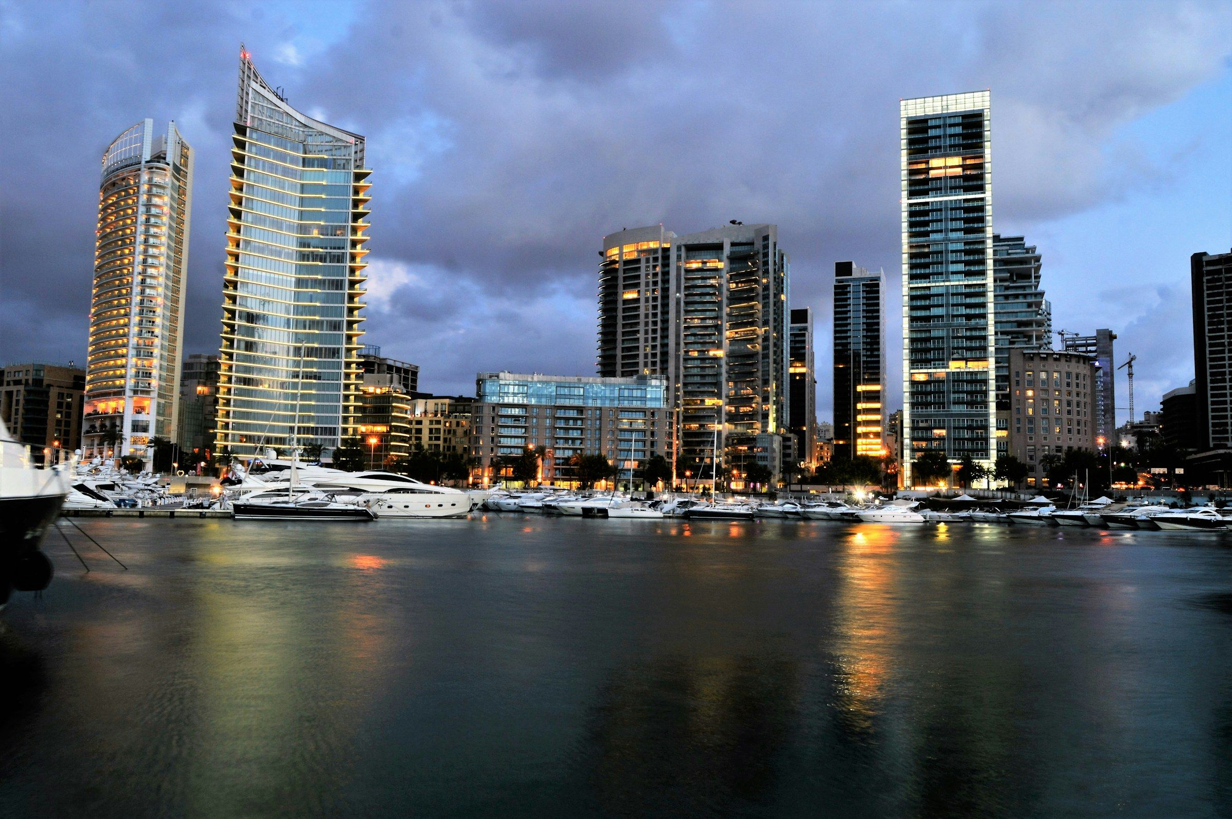 Beirut waterfront at dusk, with towers above a marina